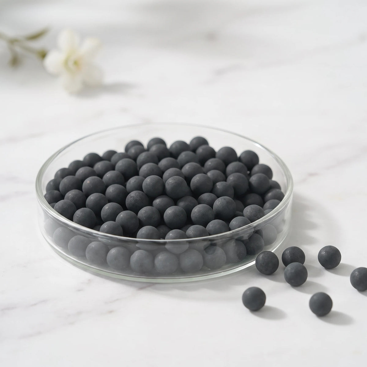 Activated carbon spheres in a glass dish