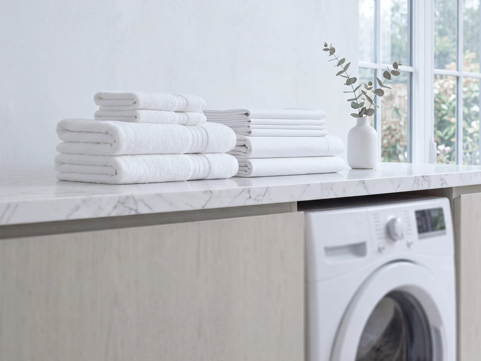 Fresh white laundry in a bright utility room