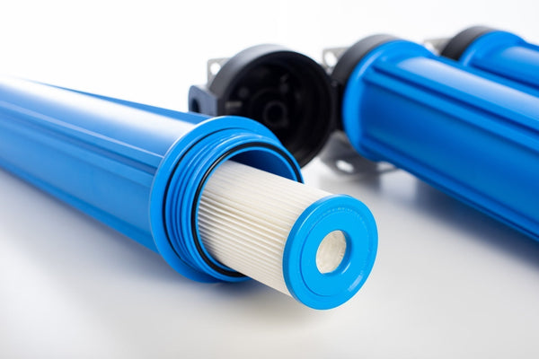 sediment water filter cartridge in blue cartridge housing