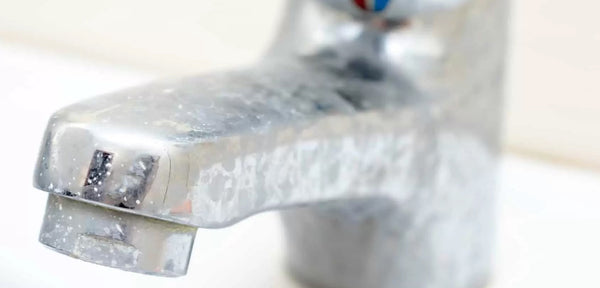 faucet with hard water spots showing impact of hard water on appliances