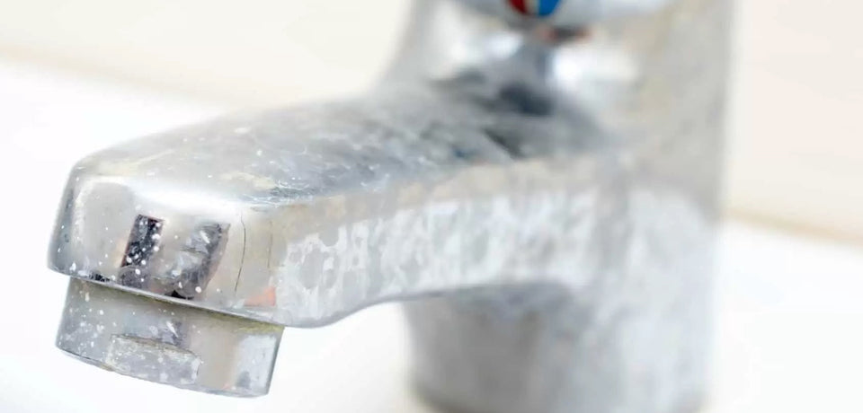 faucet with hard water spots showing impact of hard water on appliances
