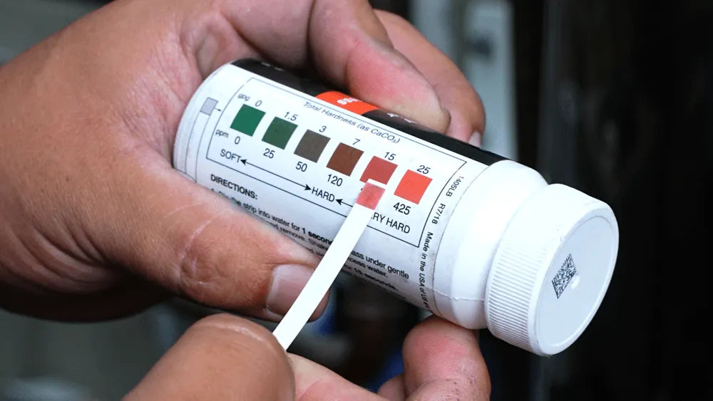 hard water testing strip indicating level of water hardness