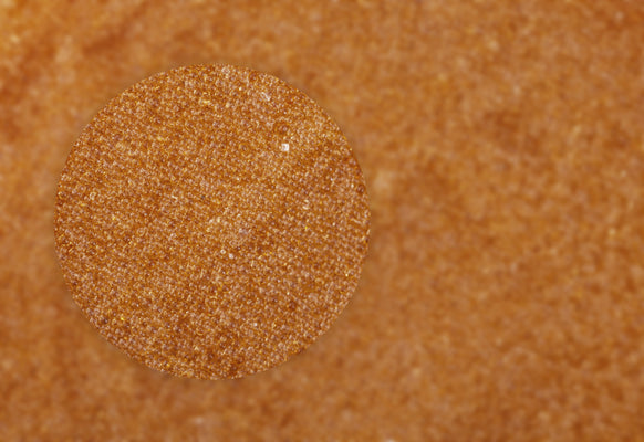 up close image of sand colored beads of ion exchange resin
