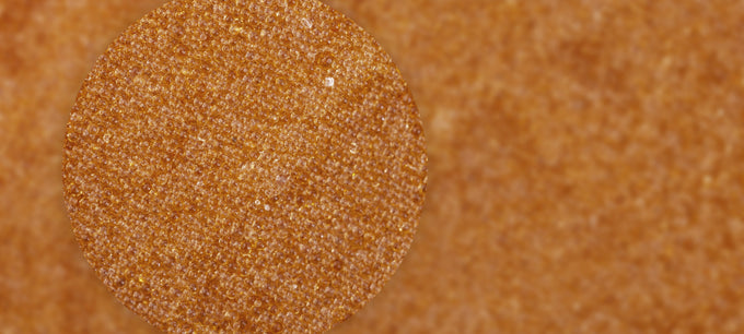 up close image of sand colored beads of ion exchange resin