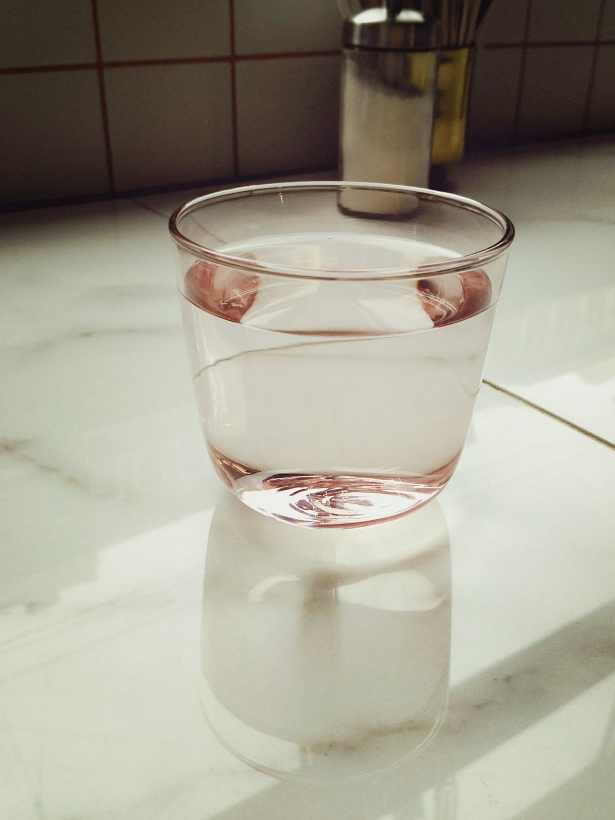 Glass of clear water on a sunlit kitchen counter, a reminder that chromium-6 is invisible