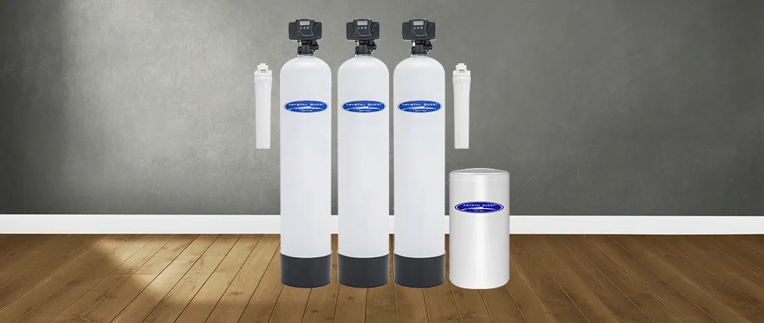 Set of water filtration systems on a wooden floor with a gray wall background
