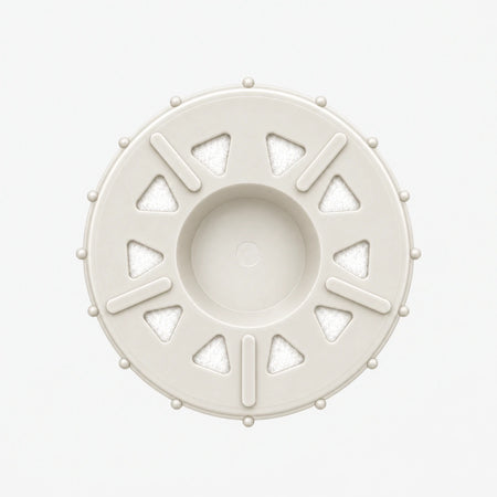 Arsenic Removal Filter Cartridge, 2-7/8 inch size: bottom end seen straight on, ten triangular openings with white pads around the center