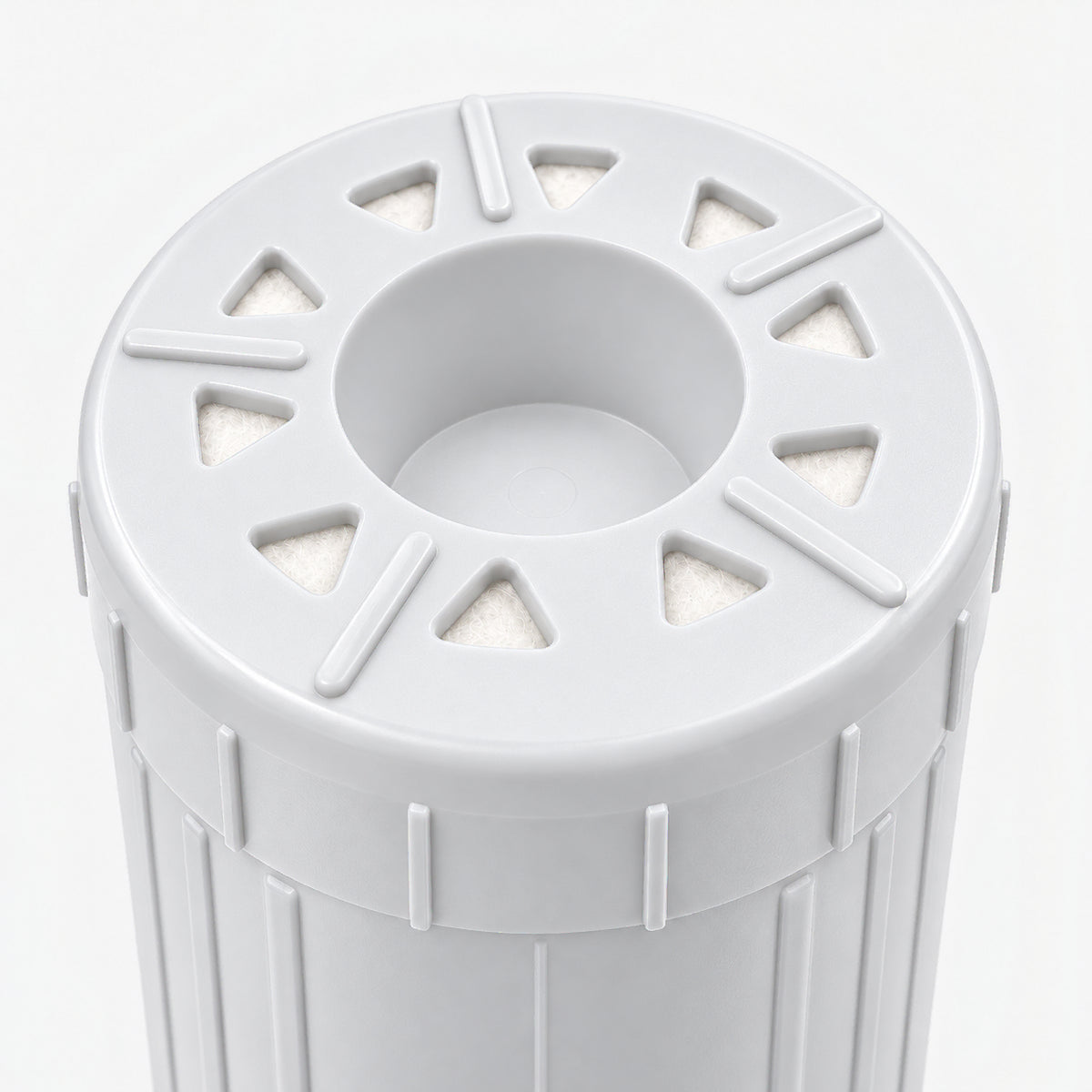 Calcium GAC Fluoride Reduction Filter Cartridge, 2-7/8 inch size: close-up of the bottom end, triangular openings with white pads around the center well
