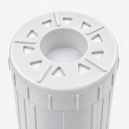 Calcium GAC Fluoride Reduction Filter Cartridge, 2-7/8 inch size: close-up of the bottom end, triangular openings with white pads around the center well
