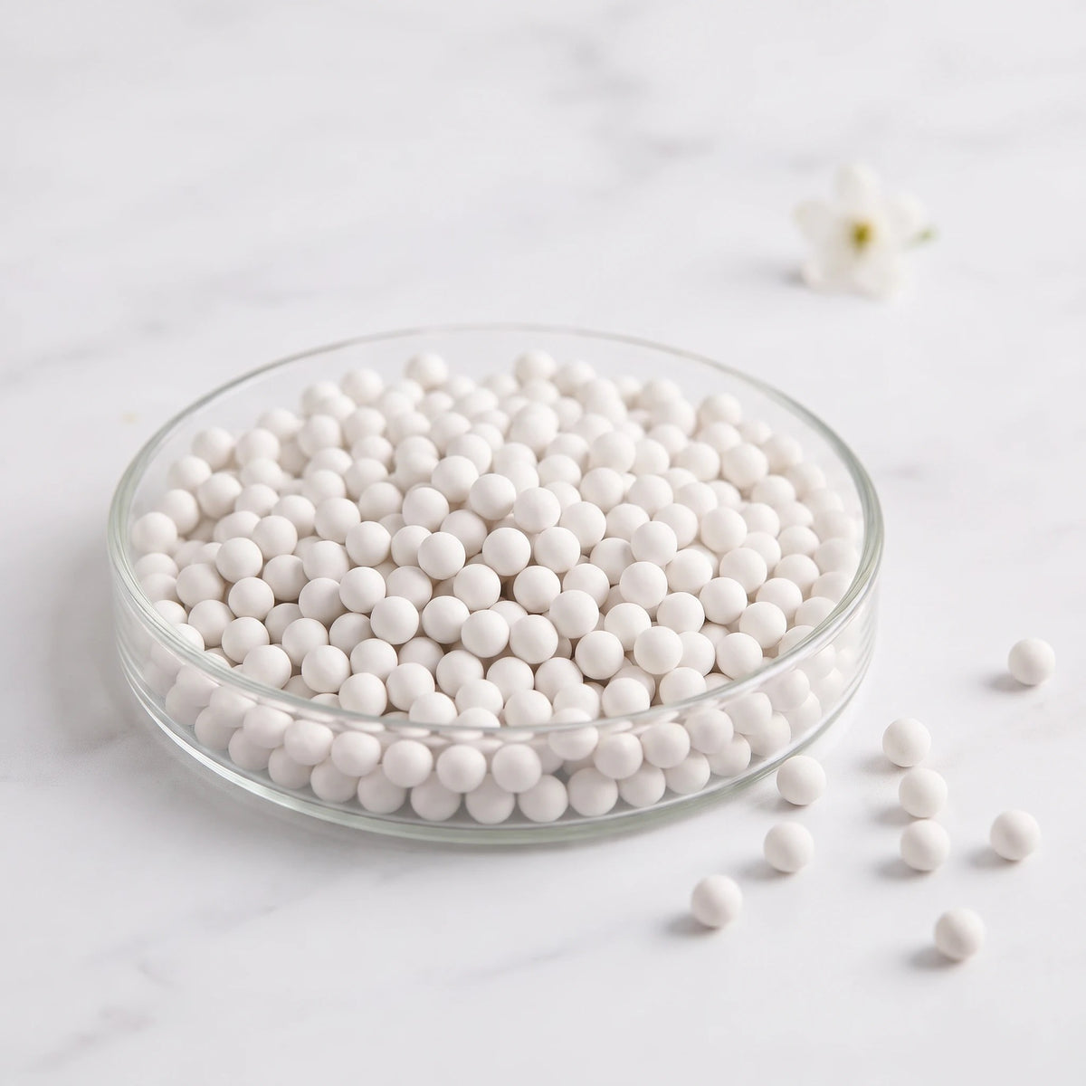 White ceramic spheres in a glass dish