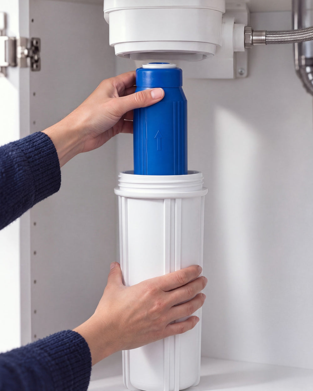 Hands lowering a SMART filter cartridge into a white under-sink filter housing