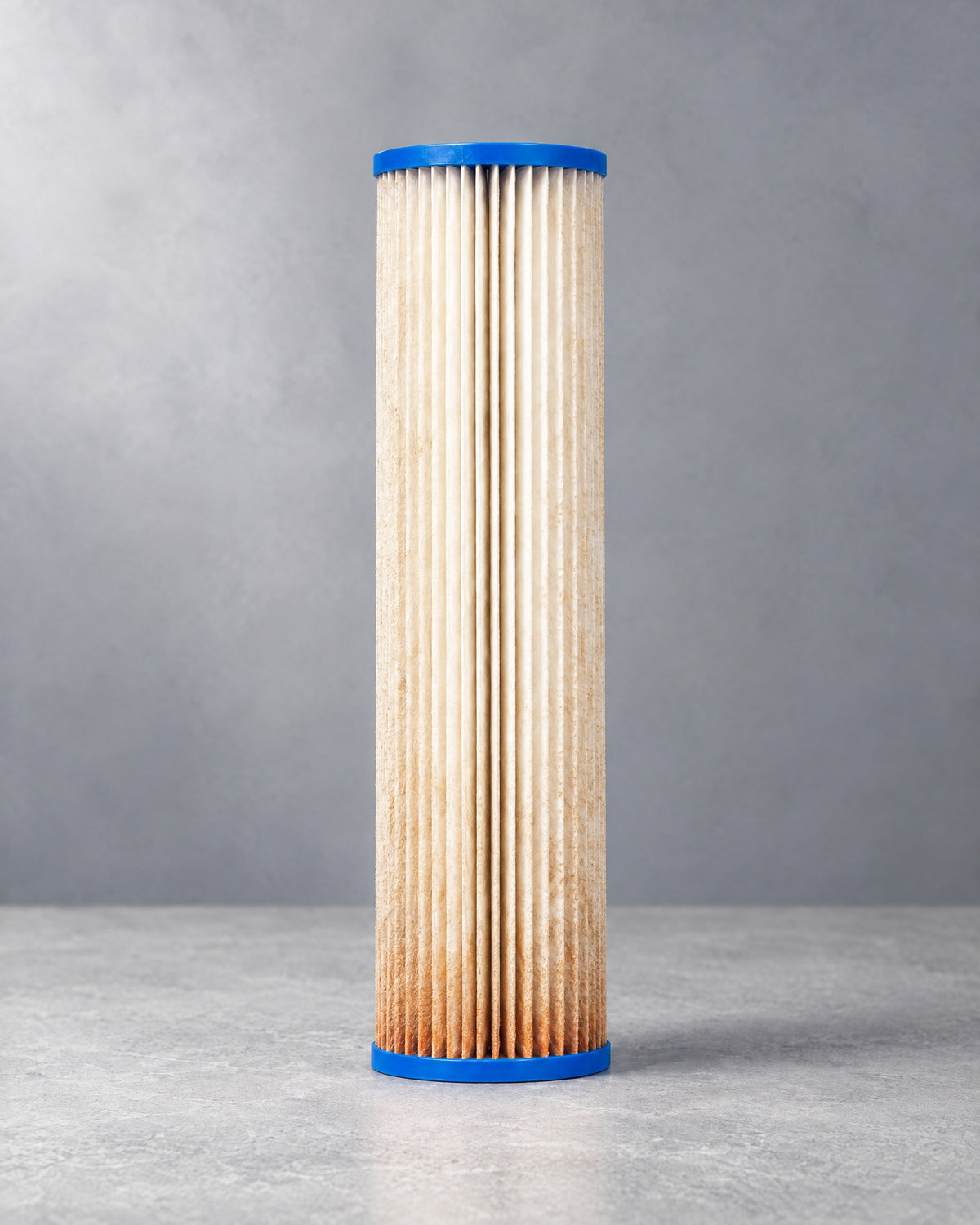 Pleated sediment cartridge after months of service, silt and rust on the pleats