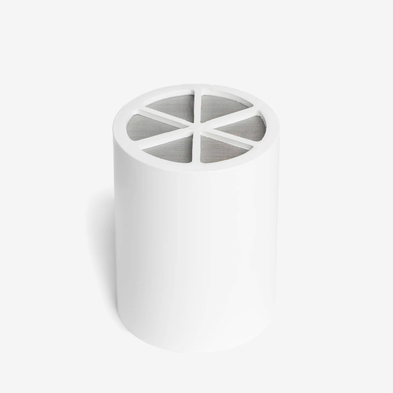 Shower Filter Replacement Cartridge, white cartridge standing upright with mesh screen top