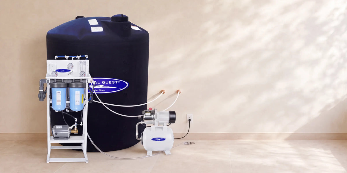 Crystal Quest Whole House Reverse Osmosis System with a 220 gallon storage tank and delivery pump, shown in an illustrative utility room
