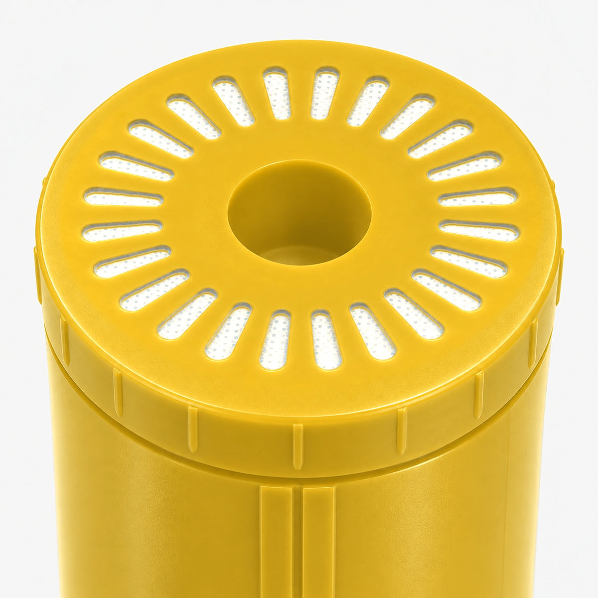 Iron Filter Cartridge, close-up of the wide yellow bottom end cap with radial slot openings
