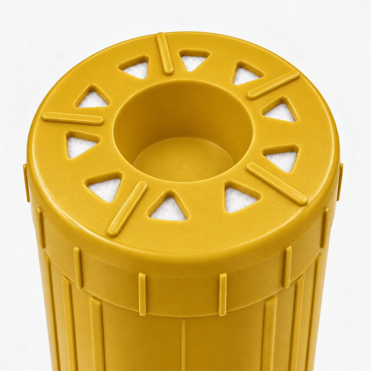 Iron Filter Cartridge, close-up of the yellow bottom end cap with triangular openings around a center recess