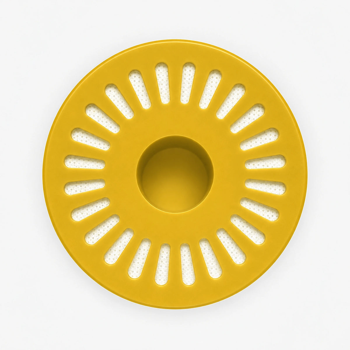Iron Filter Cartridge, bottom view of the wide yellow end cap with radial slot openings around a center hole