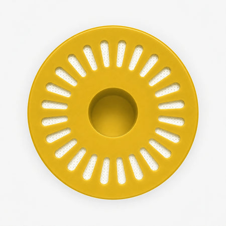 Iron Filter Cartridge, bottom view of the wide yellow end cap with radial slot openings around a center hole