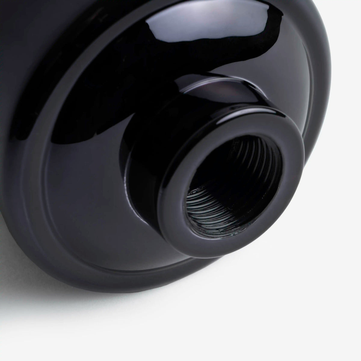 Shower Filter in black, close-up of the threaded outlet on the bottom of the housing