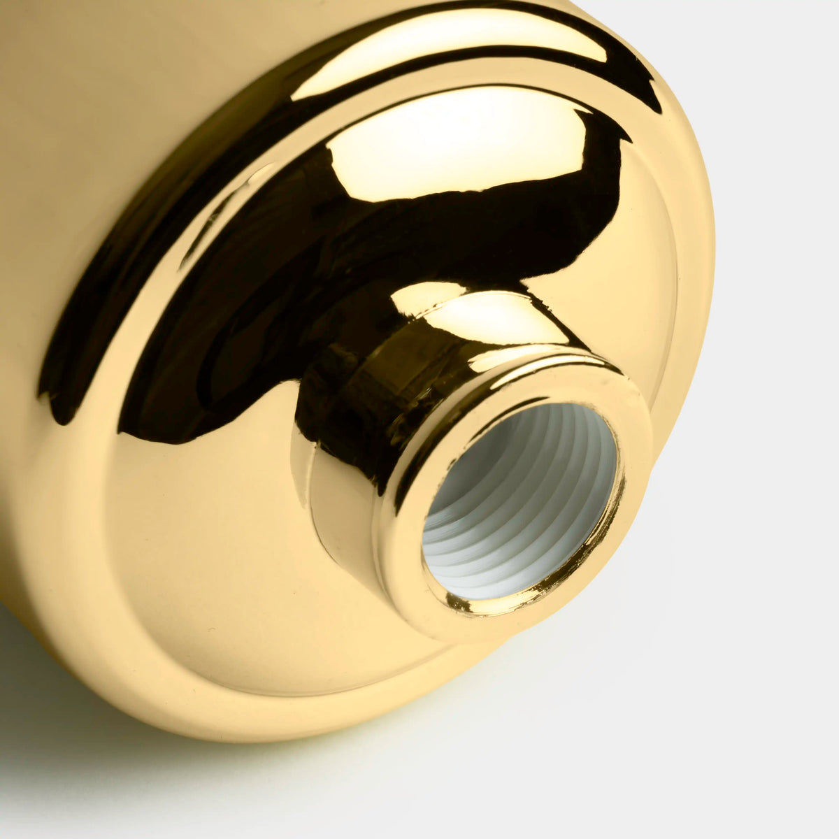 Shower Filter in gold, close-up of the threaded outlet on the bottom of the housing