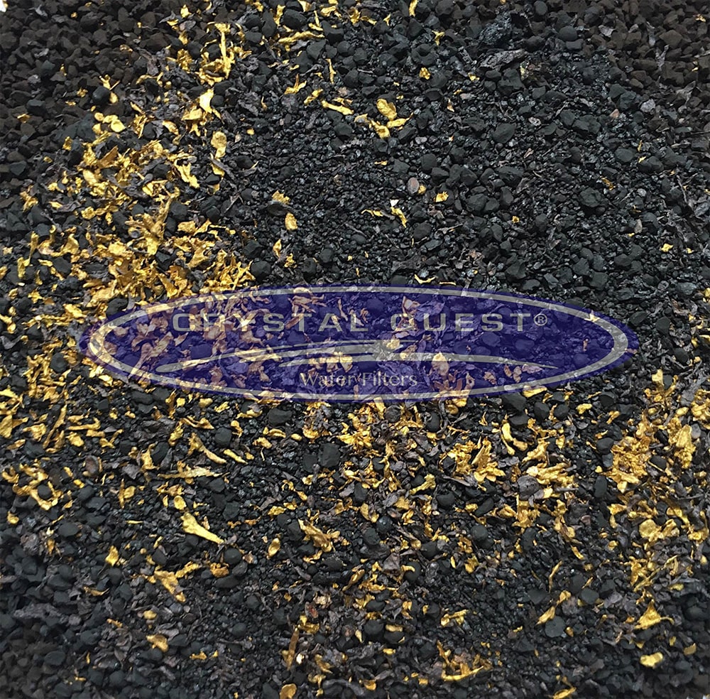 Metal Removal Media, close-up of black granules mixed with gold flakes, Crystal Quest logo overlay