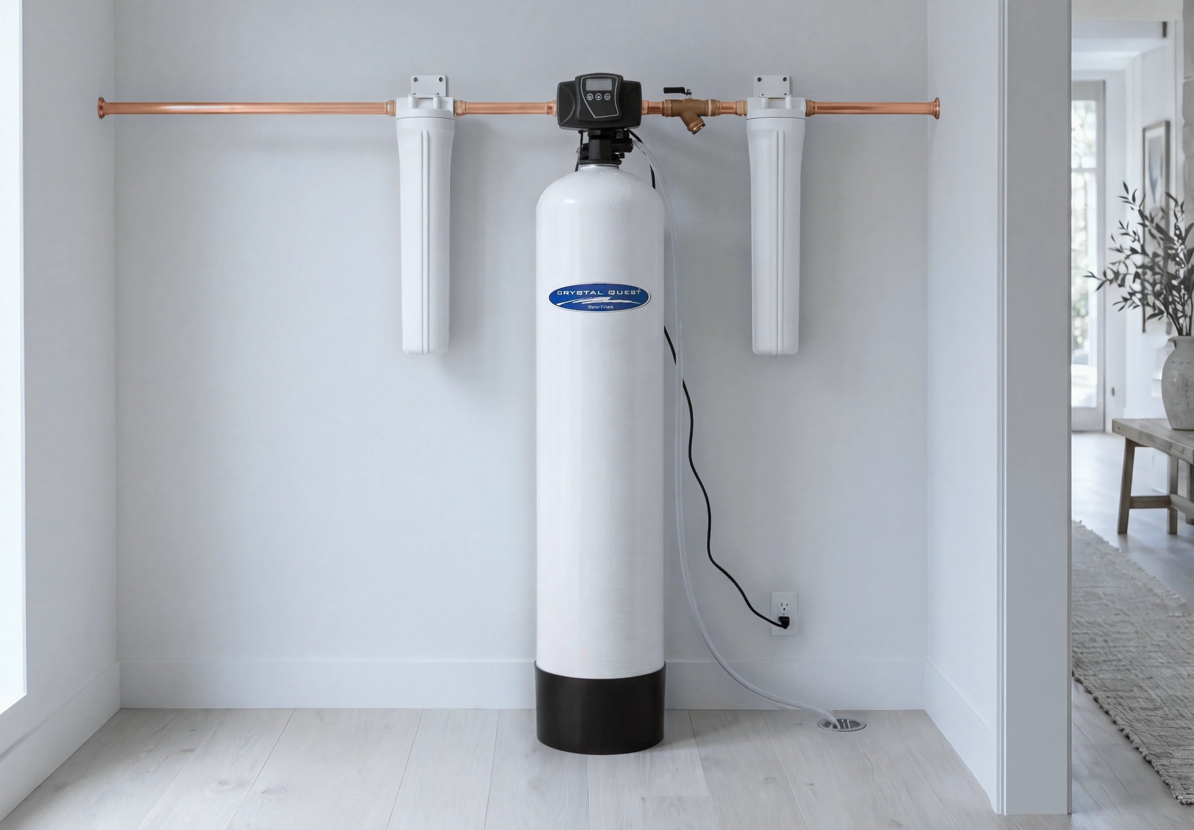 A Crystal Quest SMART whole house system on the copper main line, with a filter housing before and after the tank