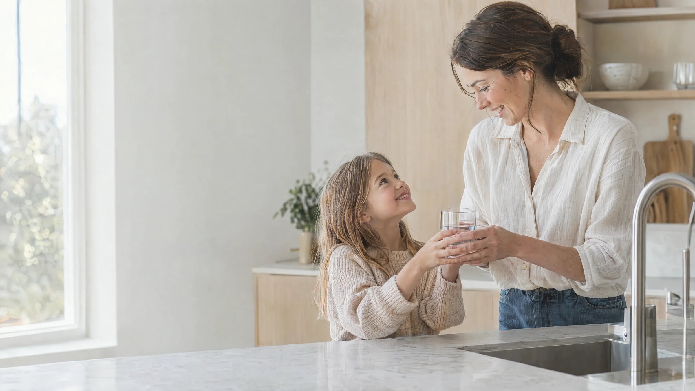 Illustrative scene of a mother and daughter filling a glass of water together at their kitchen counter